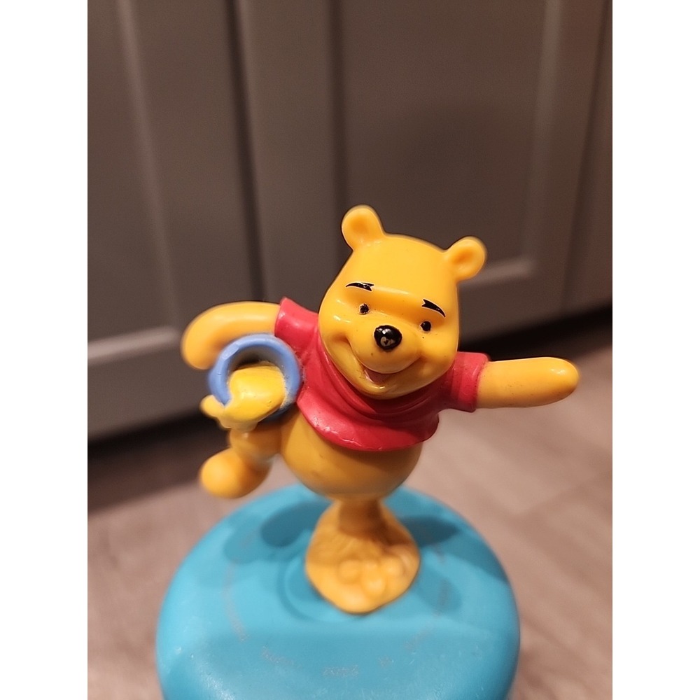 Winnie the pooh standing on one leg holding honey pot plastic toy Cake Topper